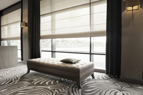 Ein Showroom für modernes Raumdesign. Eine gepolsterte Sitzbank steht auf einem gemusterten Teppich.